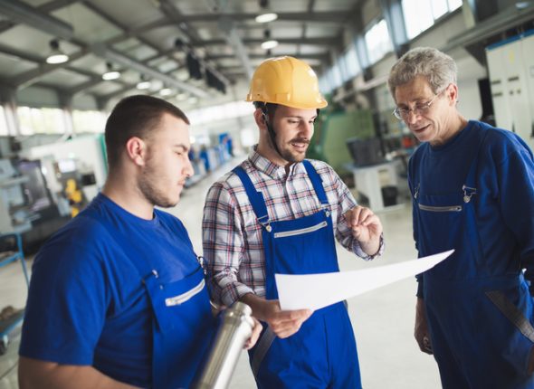 Supplier with engineer checking on production in factory